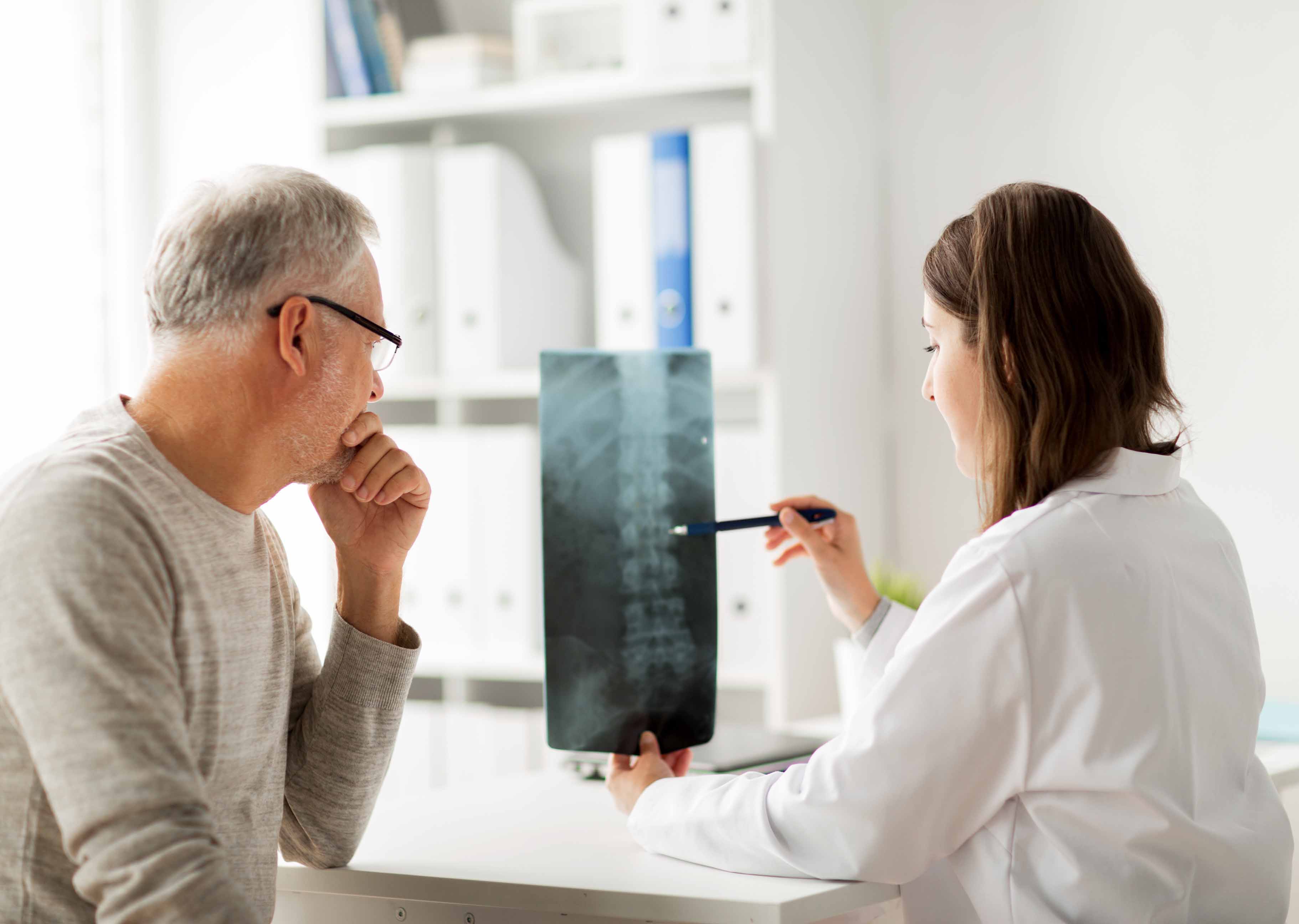 Doctor explaining a spinal x-ray to her patient