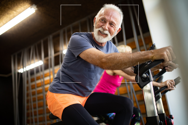 Retired Caucasian man with salt and pepper hair in a cycling class 