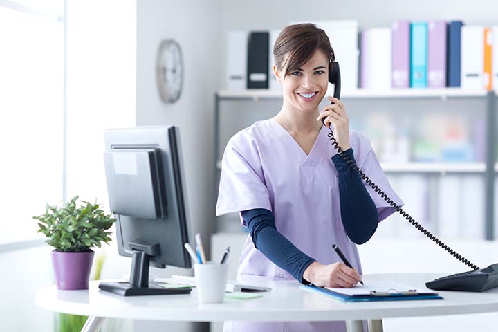 receptionist on phone with a patient 