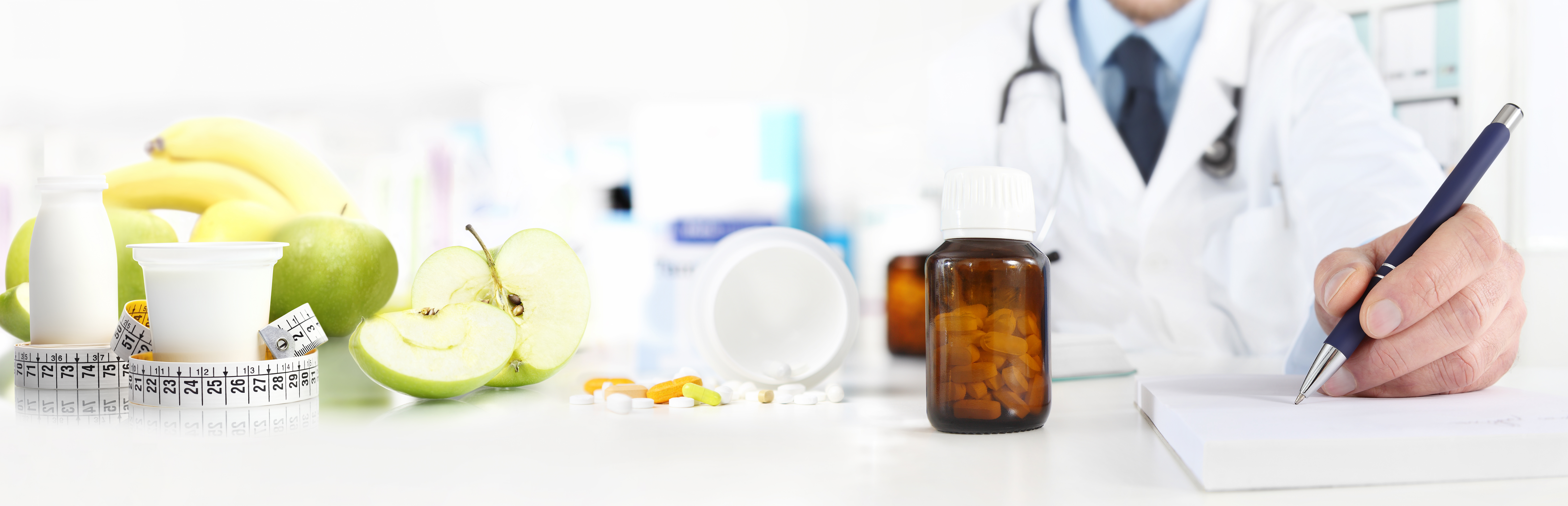Doctor prescribing medications at a table with apples and jar of medications