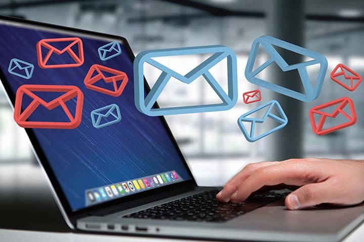 Laptop computer with red and blue email envelopes icons appearing to represent phishing and spam emails 