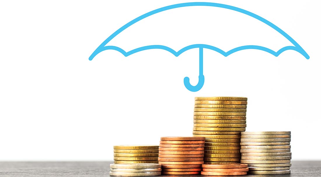 stacks of pennies nickels and quarters with a blue umbrella covering them