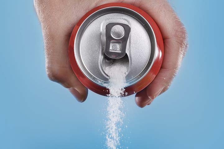 Pouring granulated sugar out of a soda can