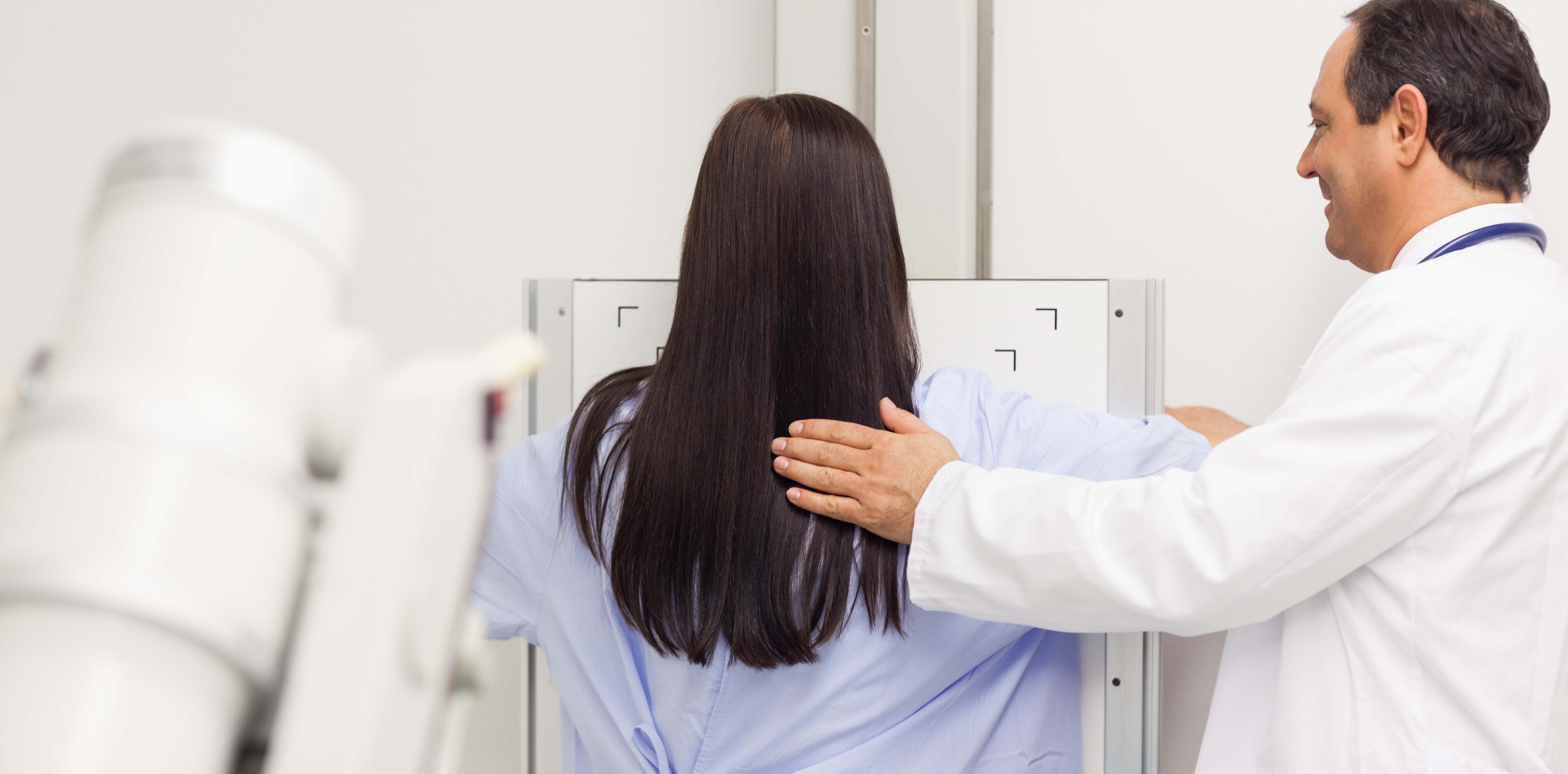 Woman with black hair getting her yearly mammogram