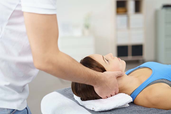 Physical therapist giving a neck massage to a patient