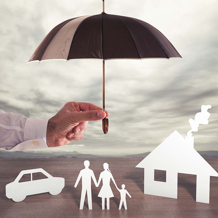 a black umbrella covering icons of people and icons of a car and house