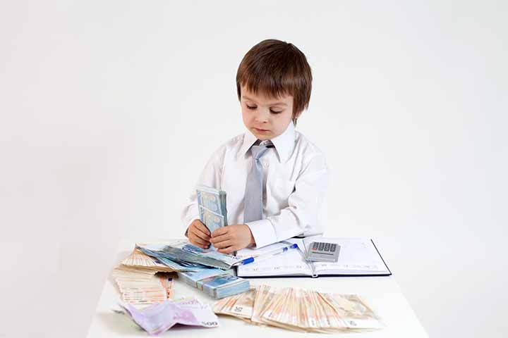 A young boy dressed as business professional in a suit counting dollars